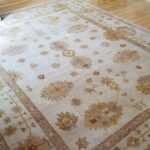 A rug in a living room with hardwood floors.