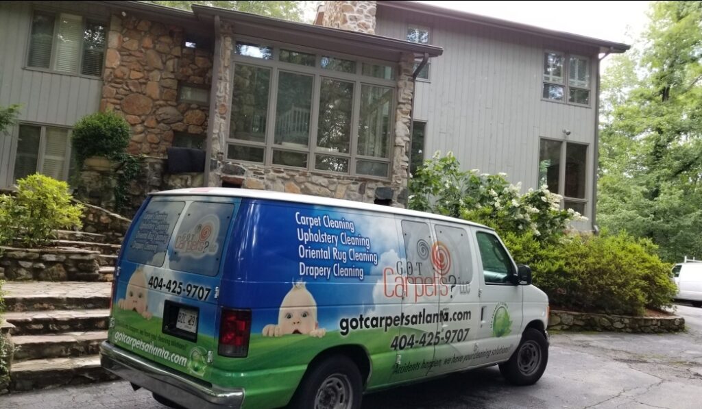 A van is parked in front of a house.